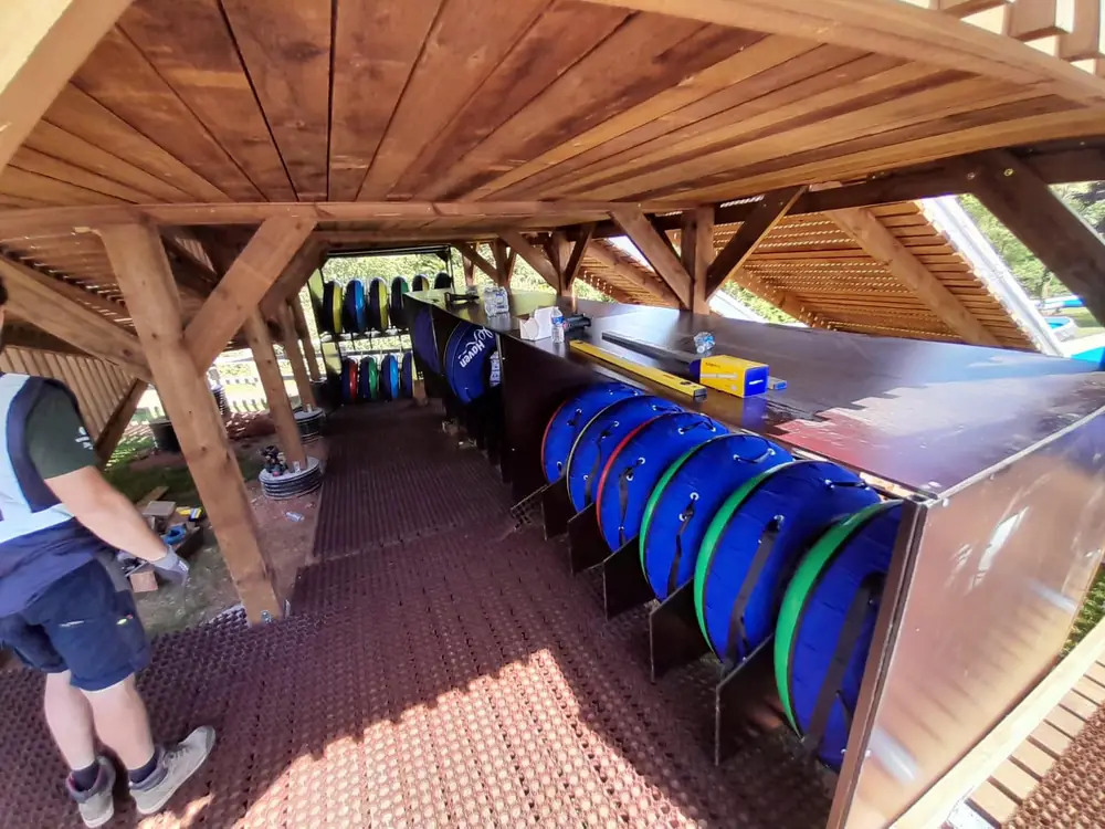 A covered tube storage rack with tubes ready for riders