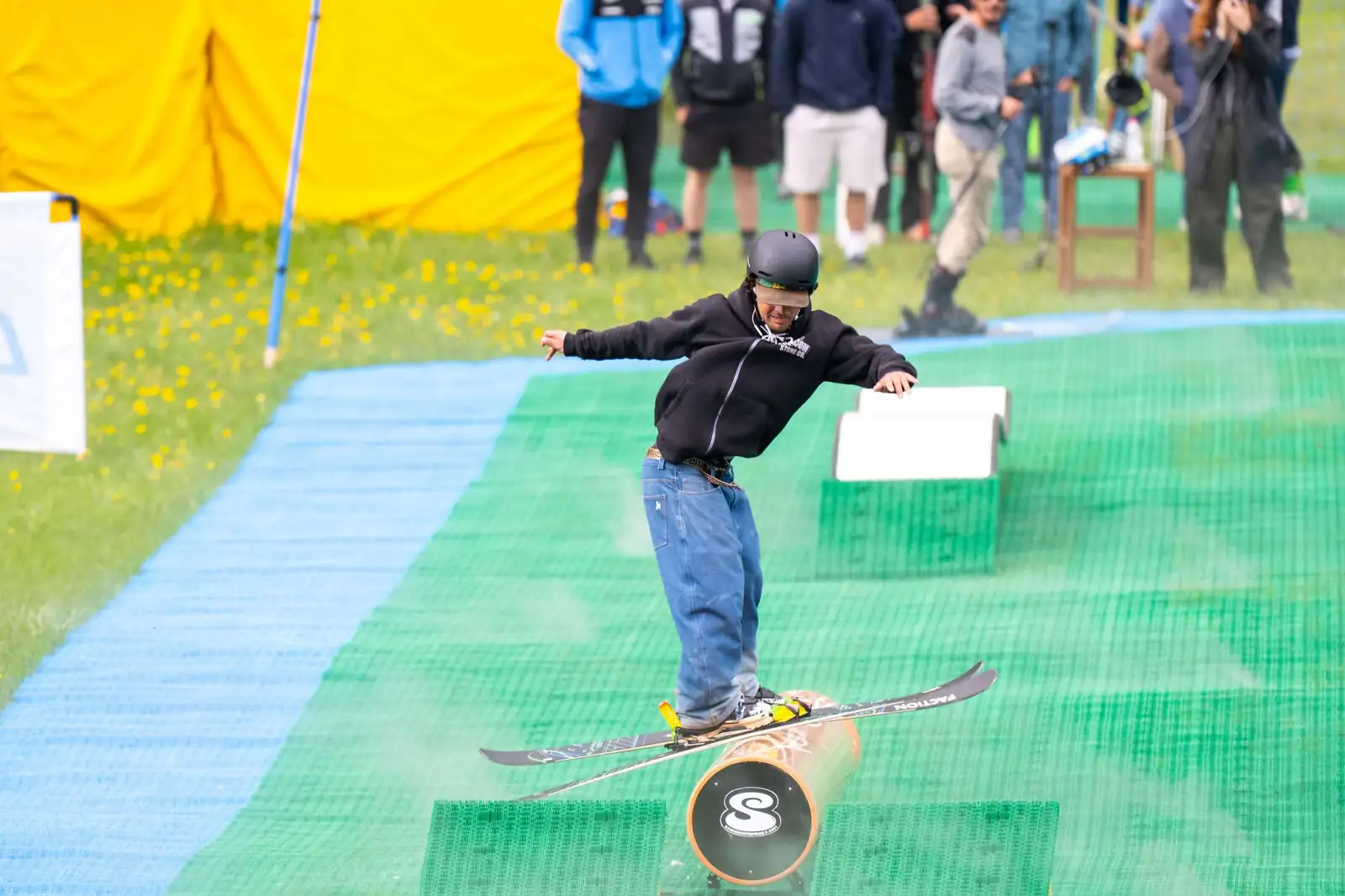 A freestyle skier on a rail on a Neveplast dry slope