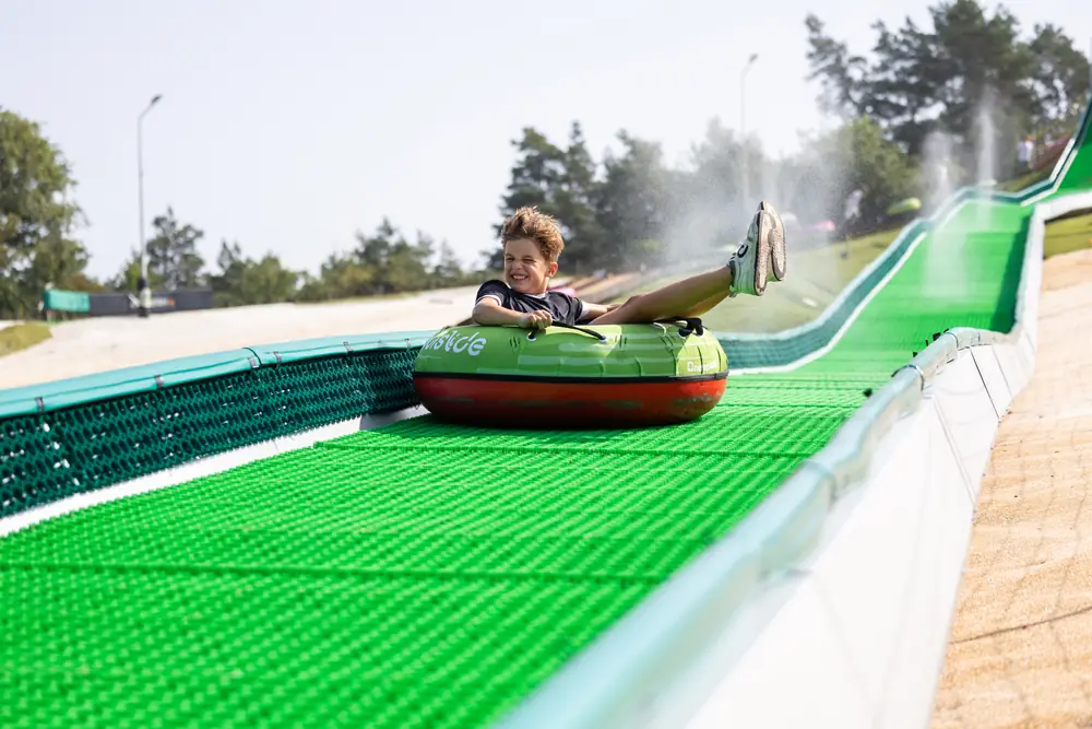 A boy in a tube on the 110 m Modislide at De Wijchense Berg